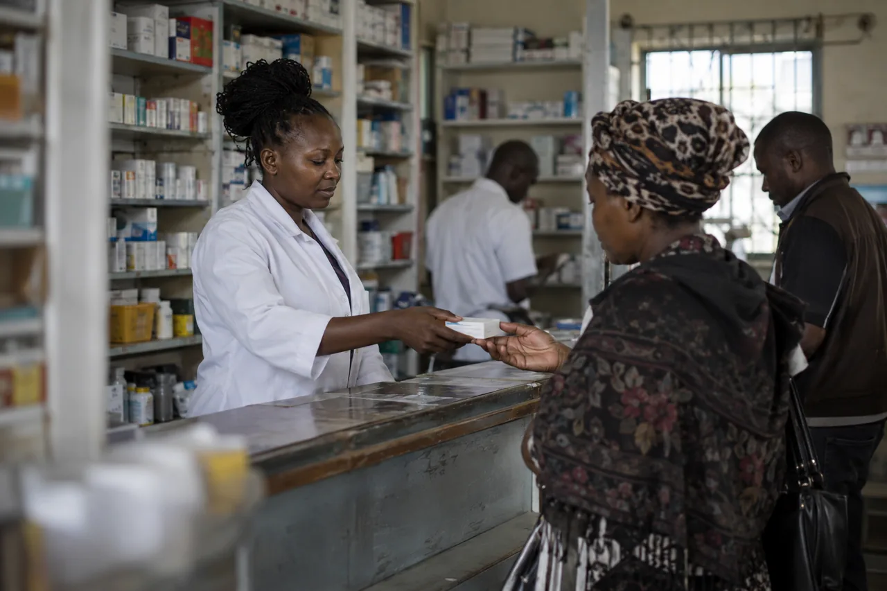 A pharmacist serving a customer at a pharmacy counter in Kenya